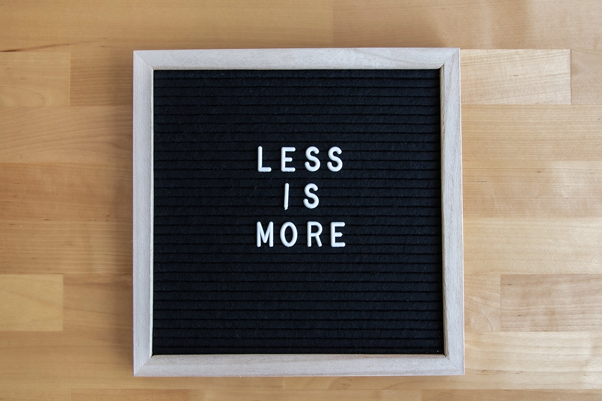 Less Is More Minimalism in web design. A sign with the letters "Less is More".